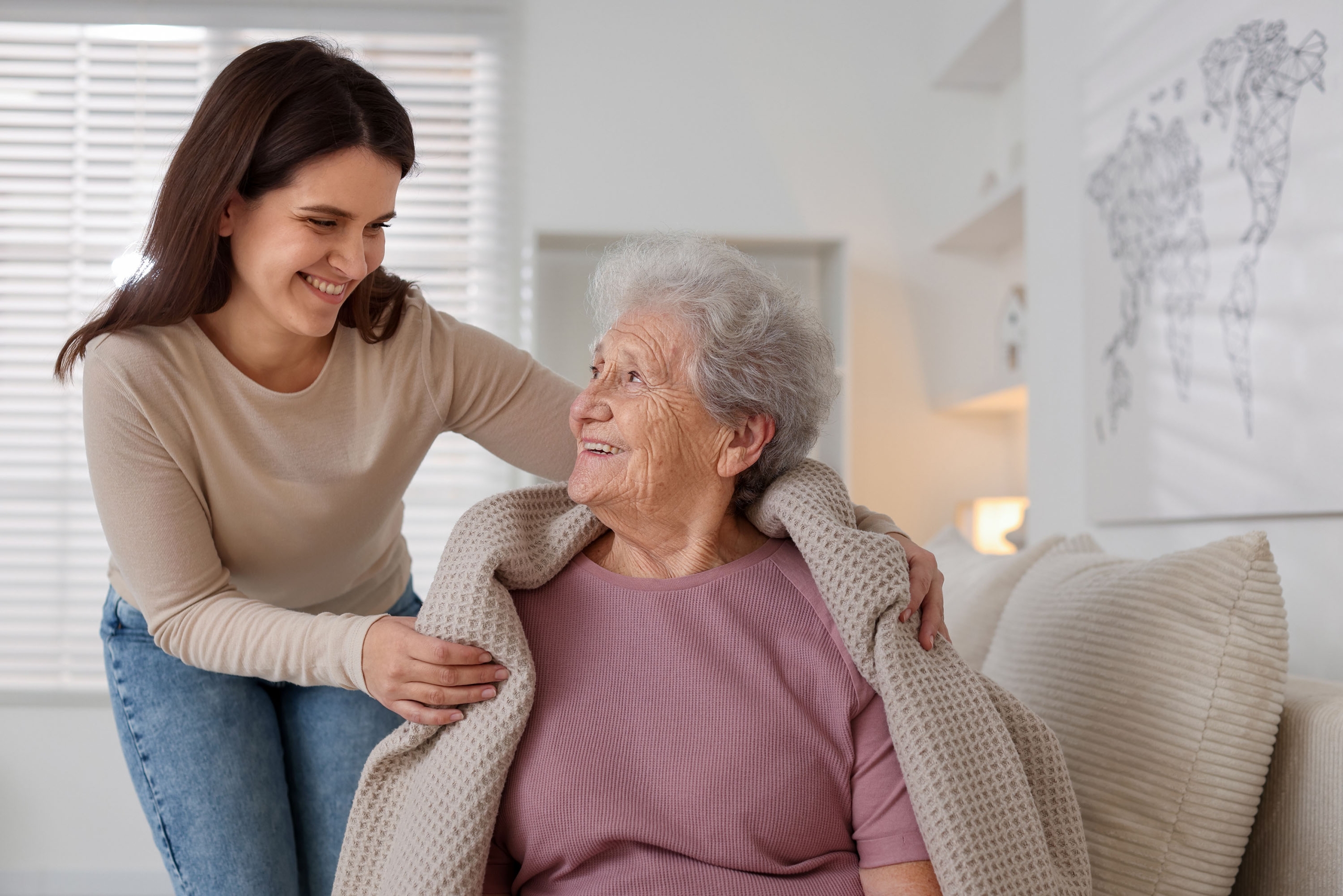 Granddaughter,Covering,Her,Grandmother,With,Blanket,At,Home.,Elderly,Care